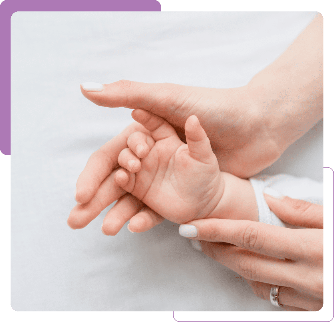 Adult hands gently holding baby's tiny hand