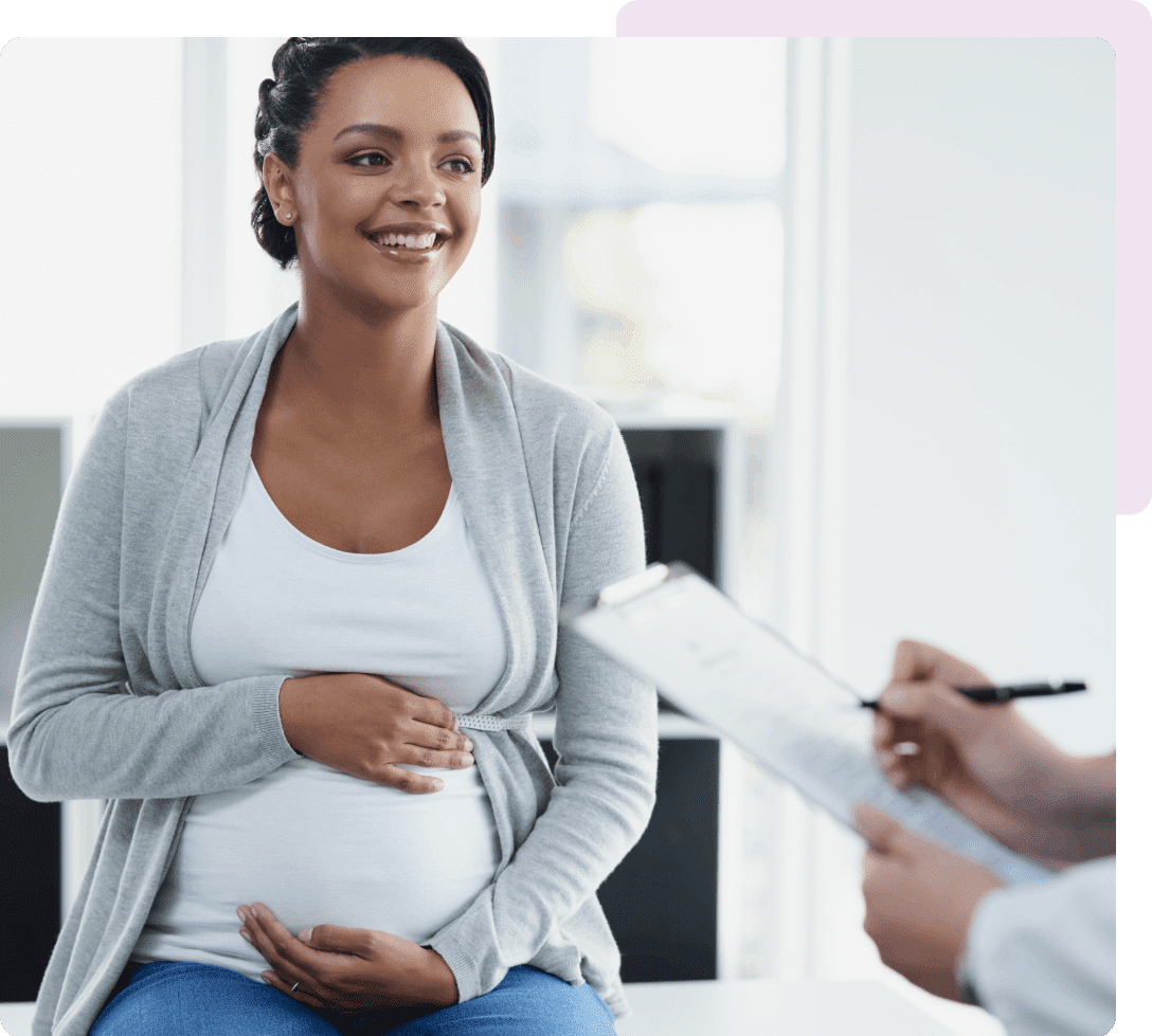 Smiling pregnant woman at prenatal appointment