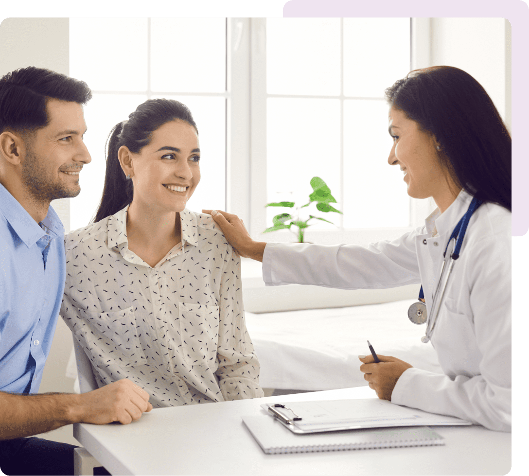 Doctor reassuring couple during medical consultation
