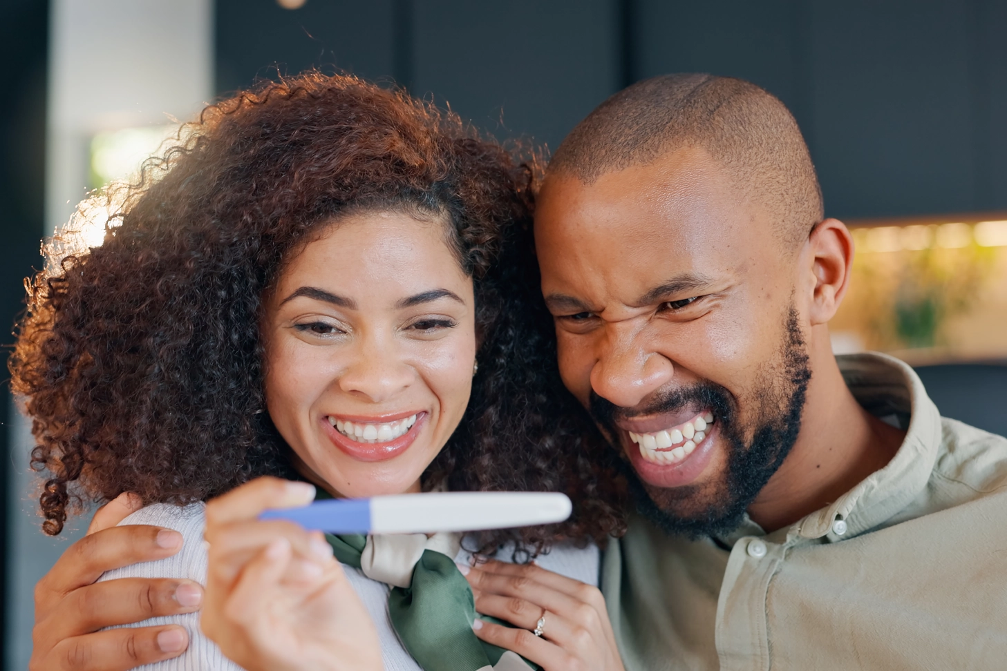 Smiling couple looking at pregnancy test
