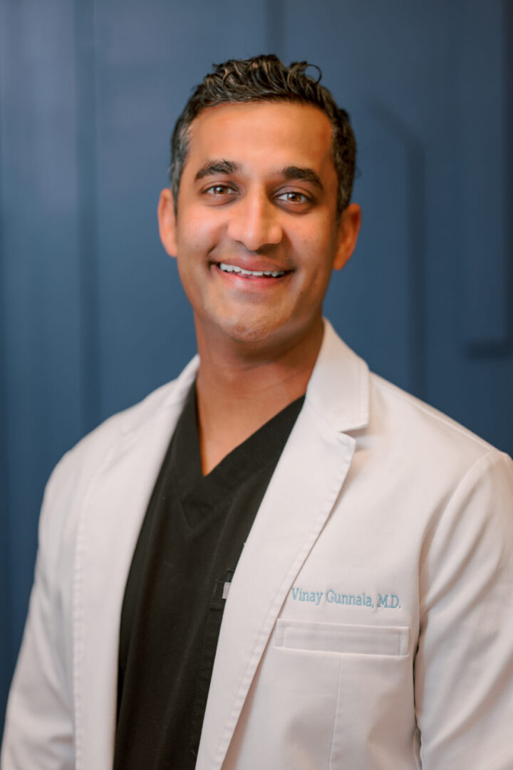 Smiling man in a white coat