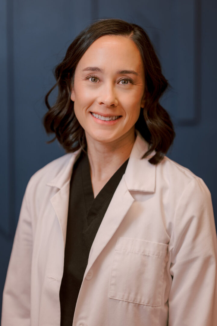 Smiling woman in a white coat