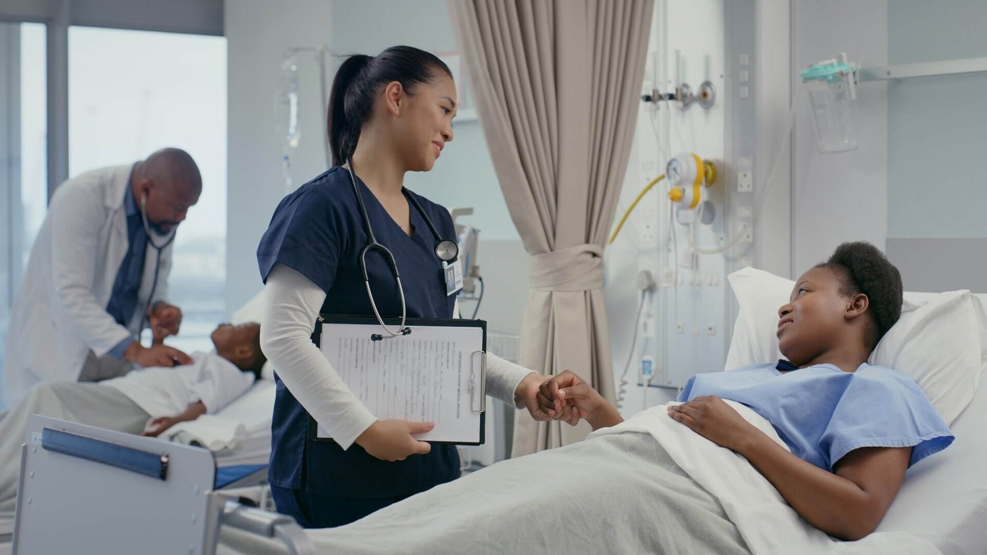 Doctor examining patient in background