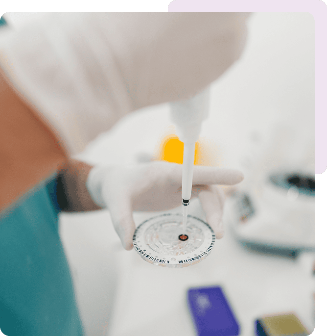 Gloved hands with lab equipment