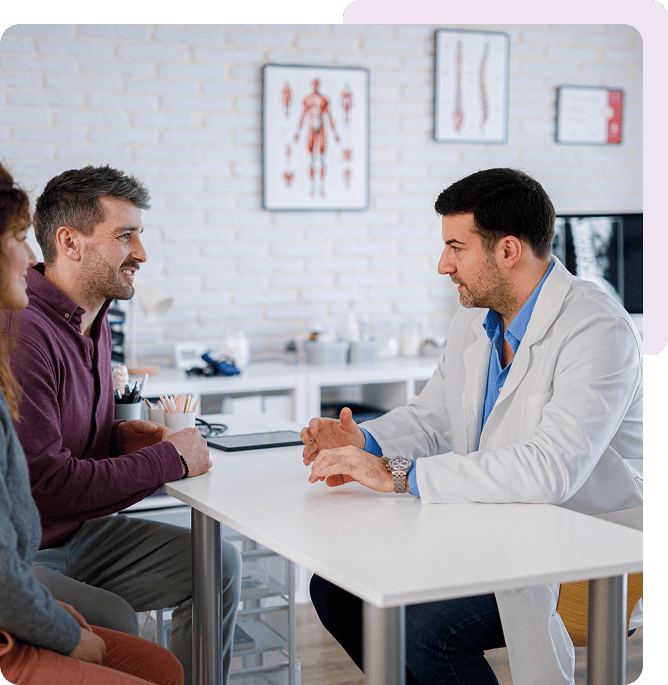 Doctor consulting with a couple at clinic