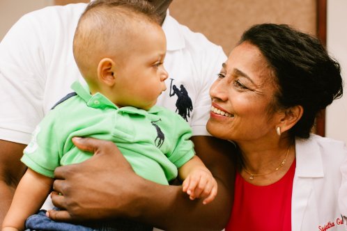 Dr. Sujatha Gunnala with a Child Dr. Sujatha Gunnala of Southwest Fertility Center